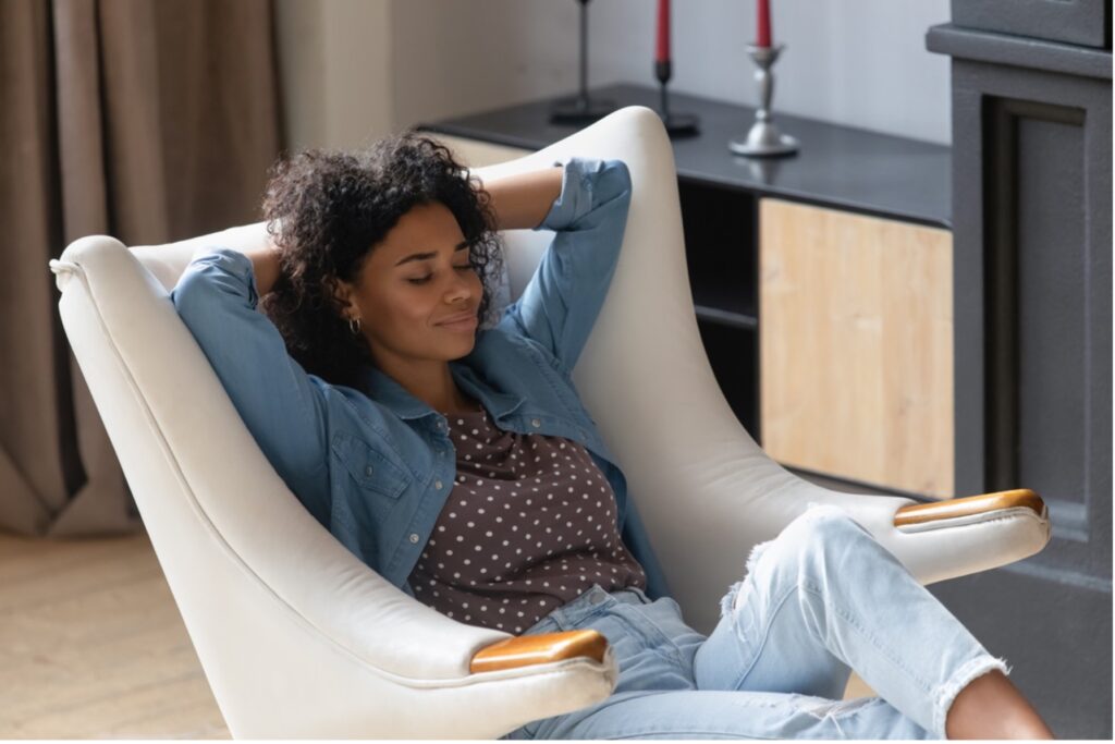 Black woman relaxing in chair.