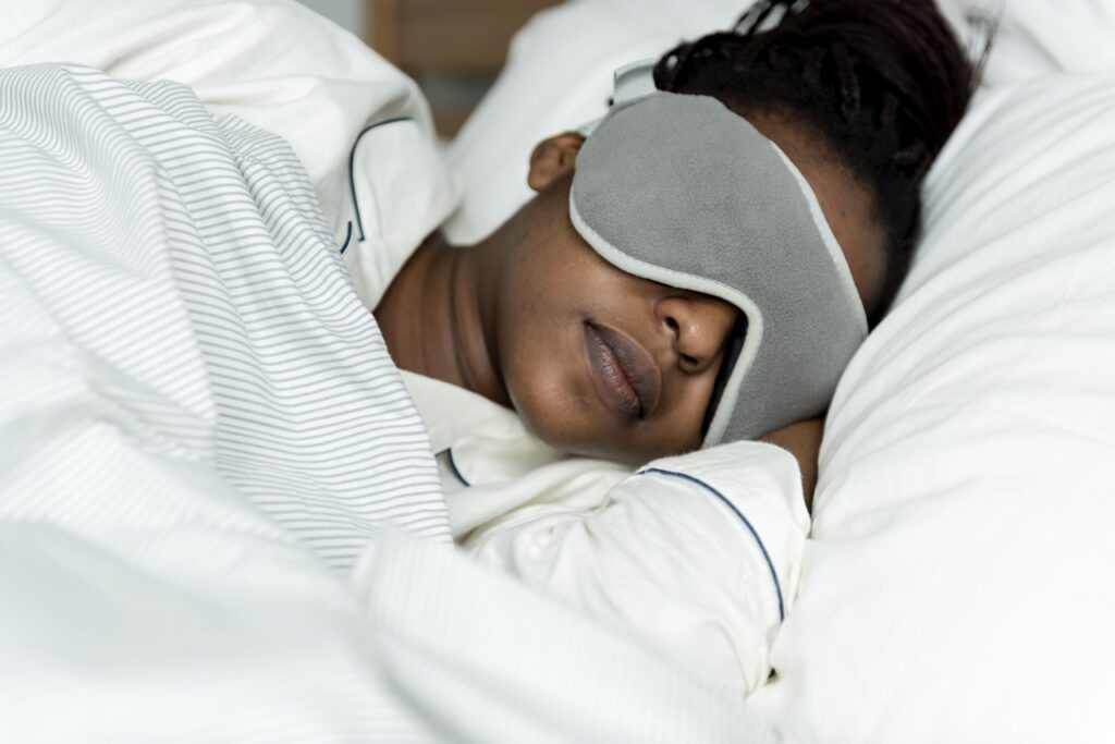 A woman sleeping with a sleeping mask