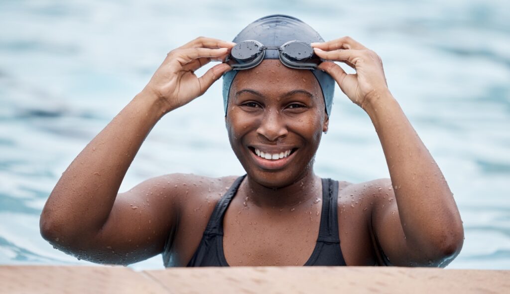 Happy black woman in swimming pool.