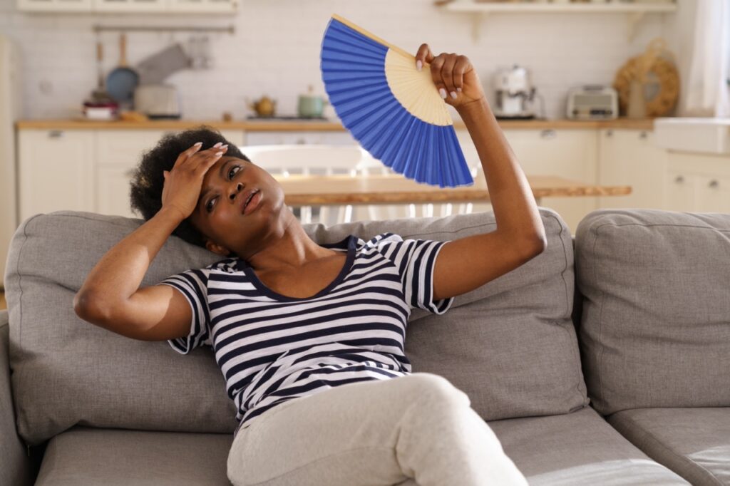 Black Woman Suffering from Menopause Hot Flash