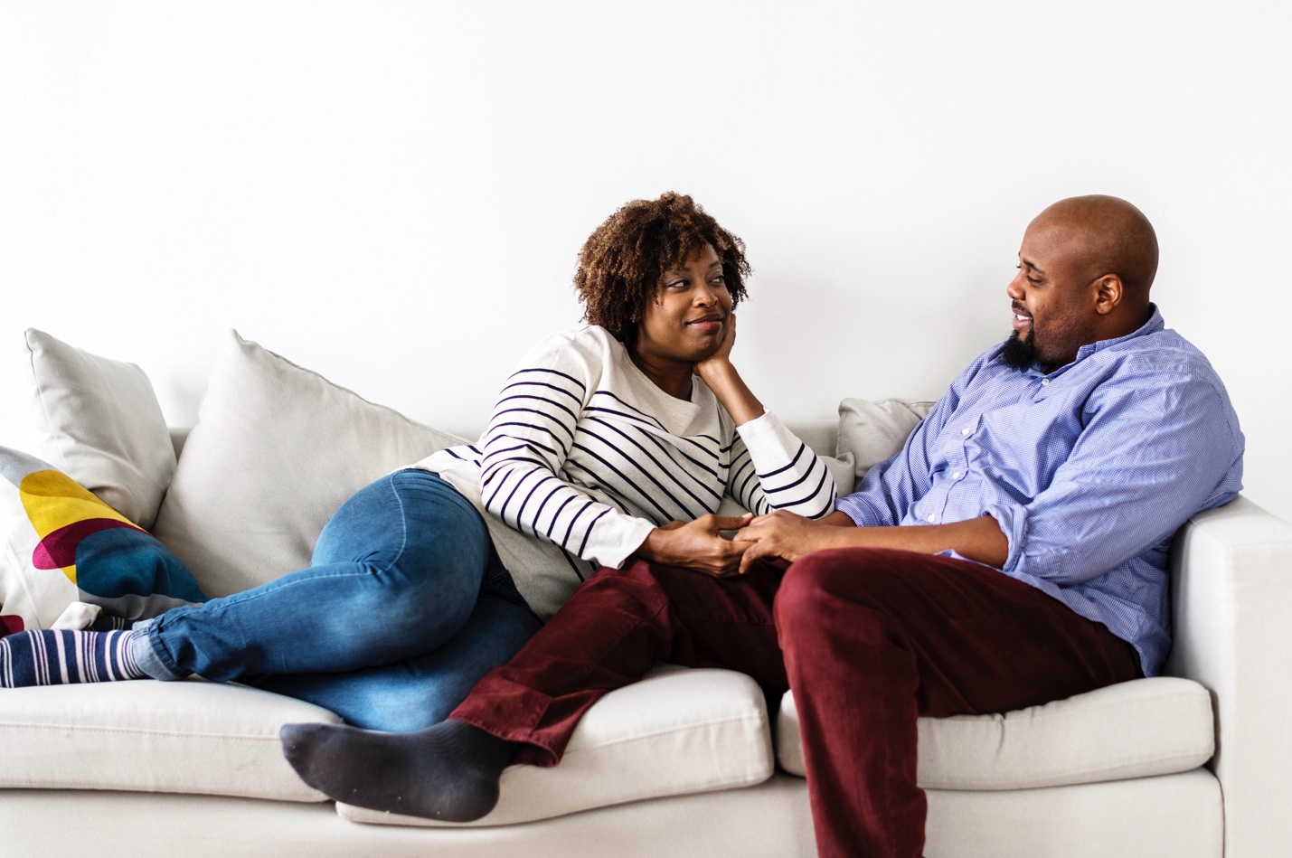 A man and woman sitting on a couch discussing menopause.