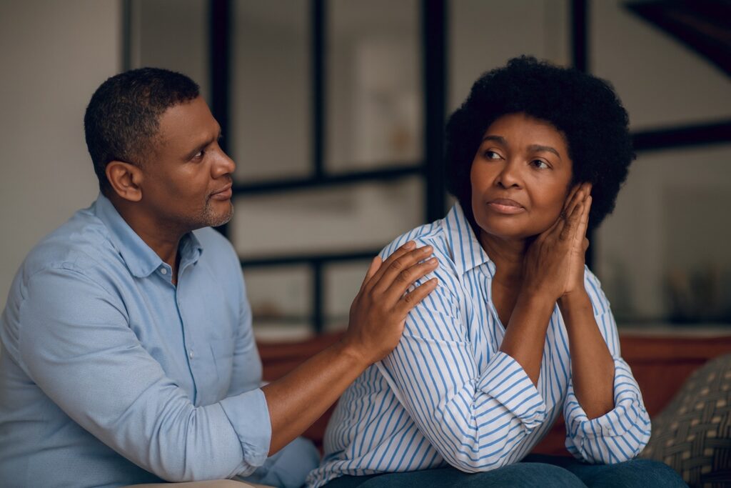 A man holding a woman's shoulder